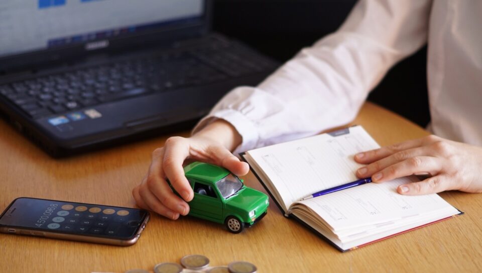 A closeup shot of a person thinking of buying a new car or selling a vehicle